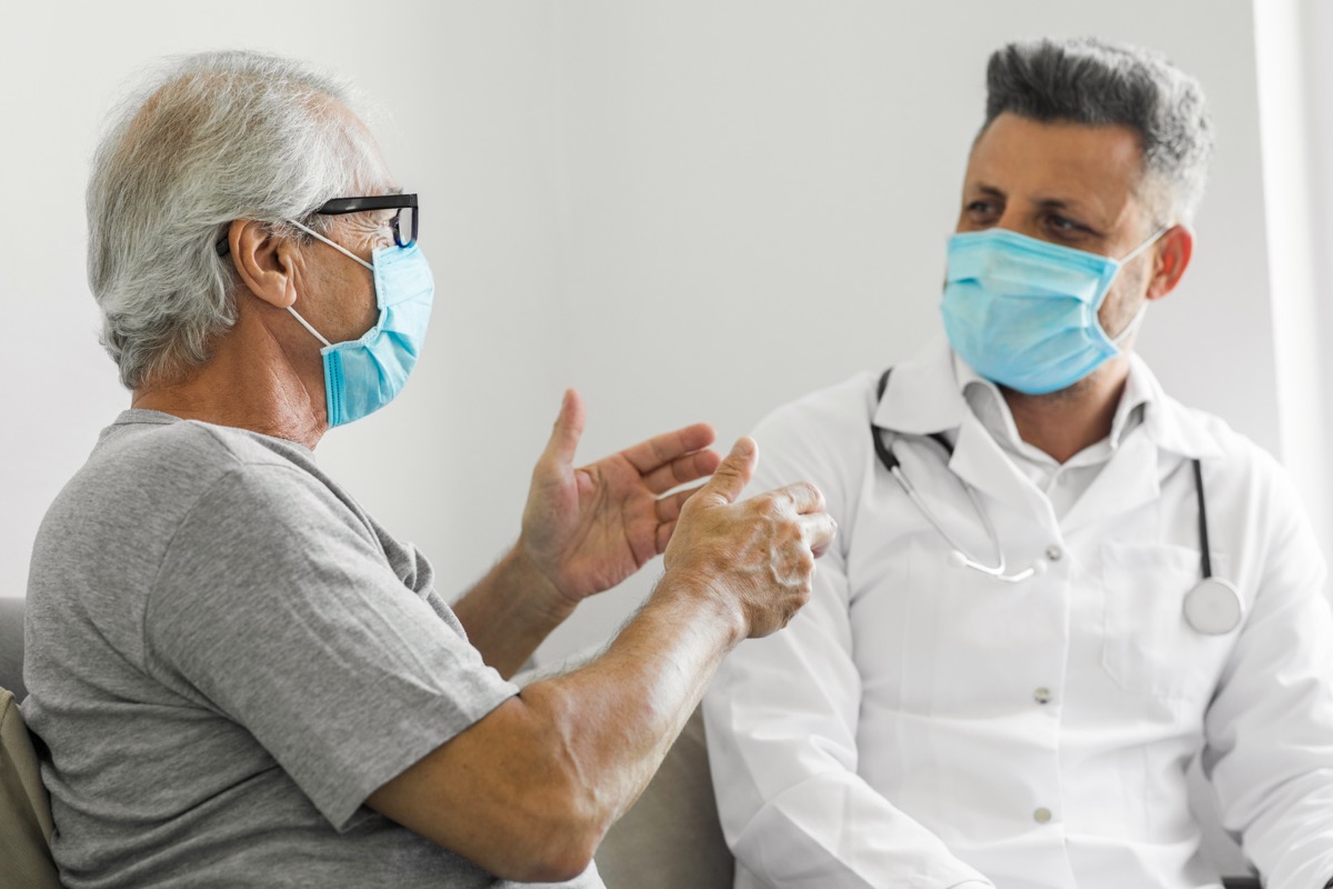 Doctor talking to a senior patient at home