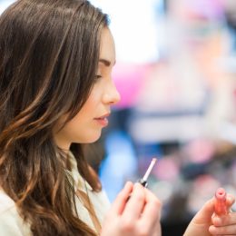 young woman trying makeup in a store