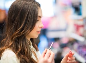 young woman trying makeup in a store