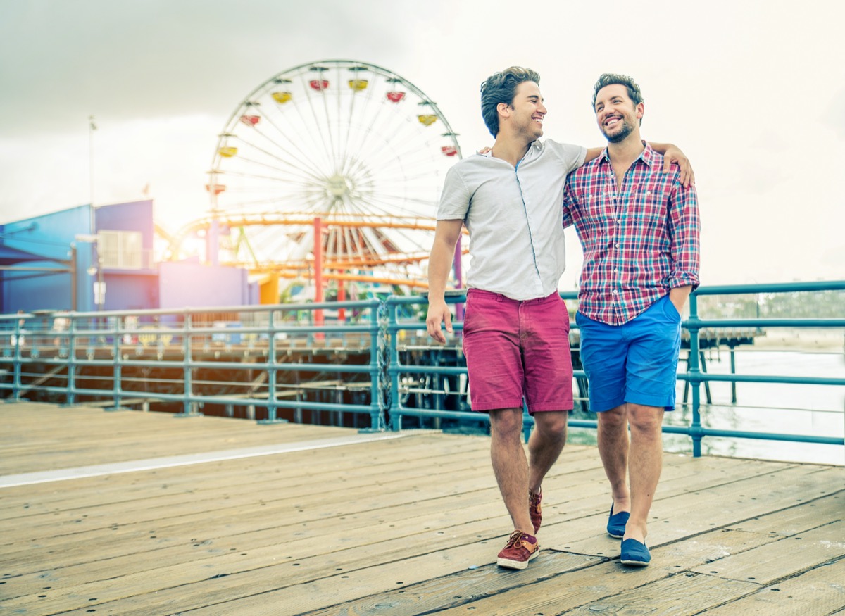 Young men on a date at a beach boardwalk