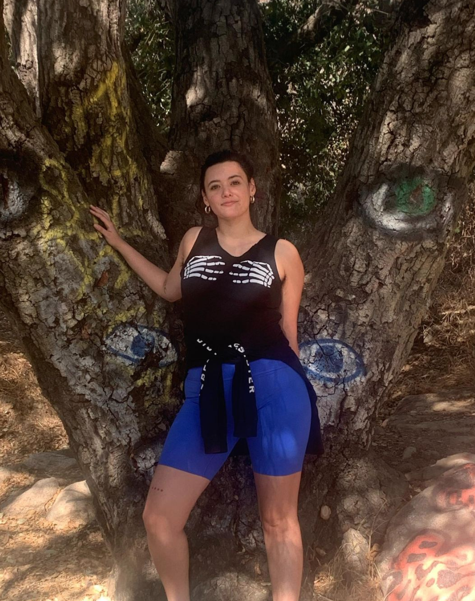 Rivkah Reyes posing in front of a tree in an Instagram post.