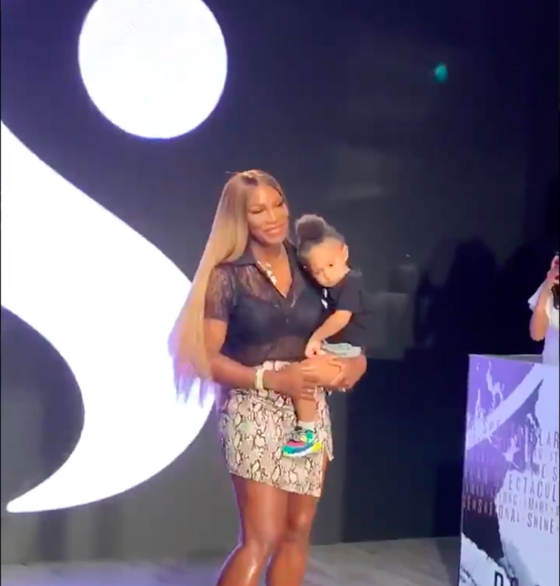 Serena Williams holding daughter Olympia at fashion show