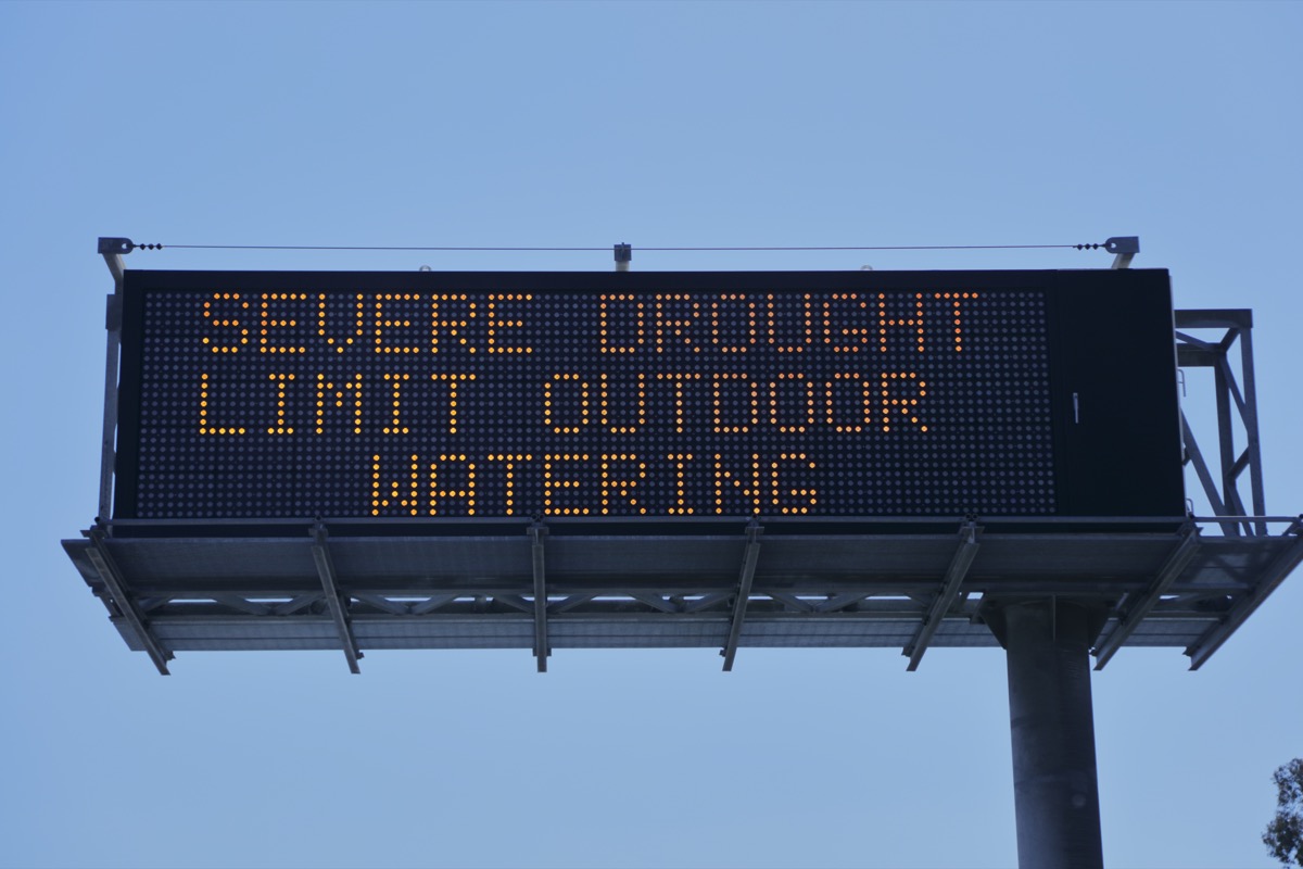 Road sign that says "Severe drought, limit outdoor watering"