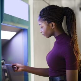 Woman withdrawing money from a cash machine