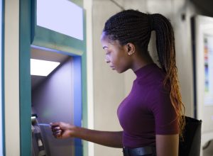 Woman withdrawing money from a cash machine