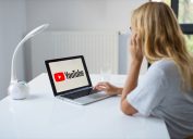 blonde woman watching youtube on computer
