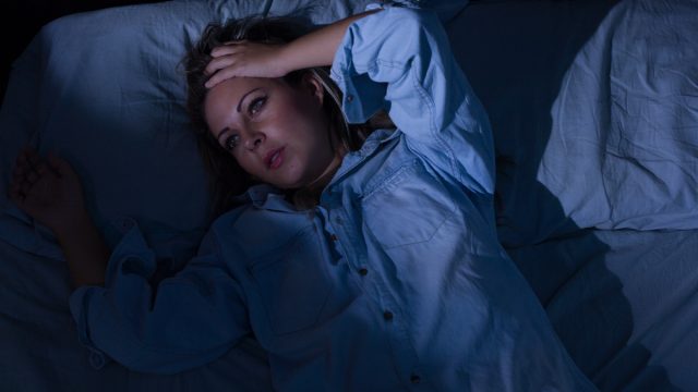 Young woman awake at night