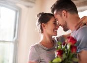 relationship quotes - smiling couple in love with red roses