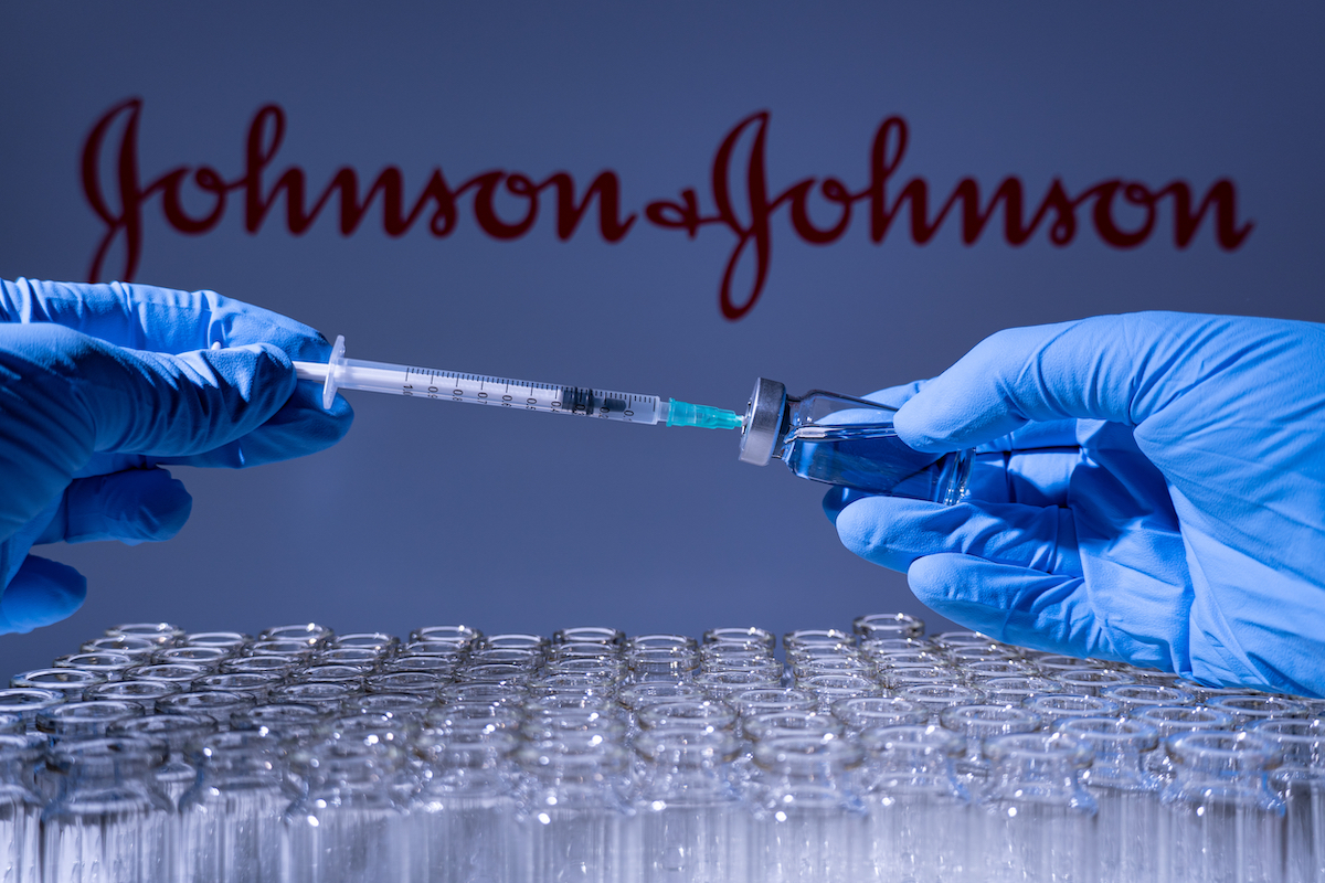 A health worker prepares to administer a shot of the American vaccine Johnson and Johnson. Name is blurry and vials containing mRNA technology vaccine