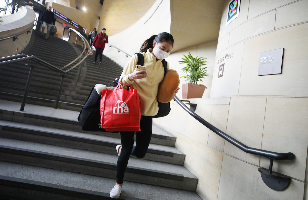 A woman wears a face mask while carrying bags in Union Station on March 13, 2020 in Los Angeles, California. The state of California is now reporting 247 confirmed cases of COVID-19 with six deaths. Many more carry the virus but have not been tested, according to officials. 