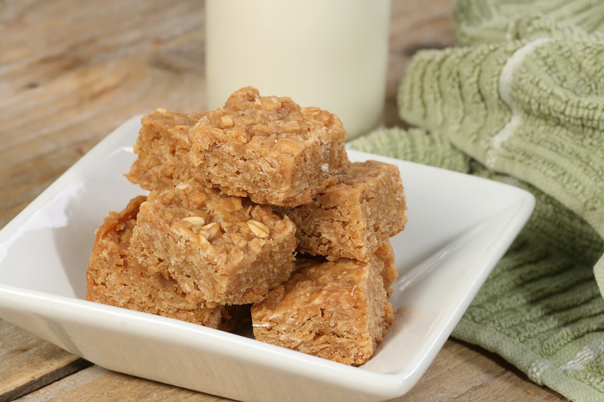 oat bars on a white plate and glass of milk