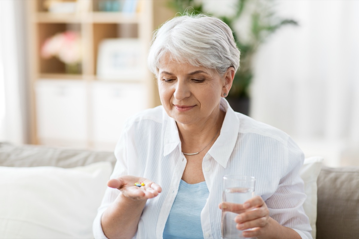 older woman taking pills