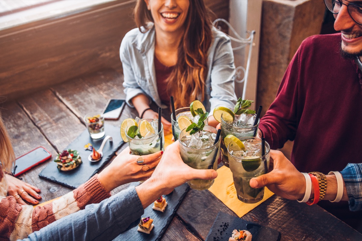 Group of friends toasting with mojitos