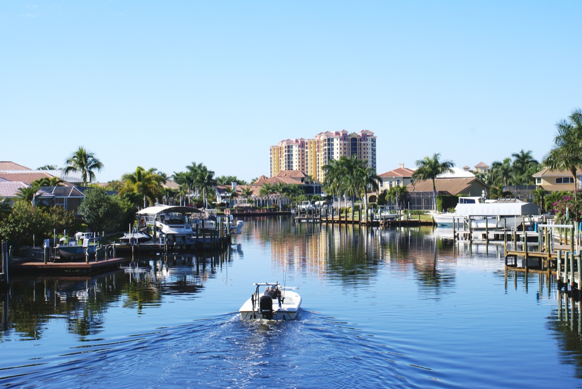 boat in water, cape coral, florida, canal, palm trees