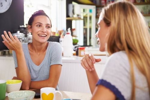 Woman talking at table at home together