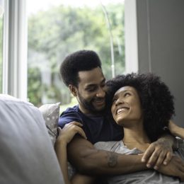 couple lying down and having romantic moment on couch