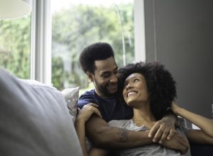 couple lying down and having romantic moment on couch