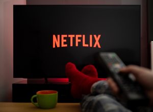 person in red socks watching netflix on tv