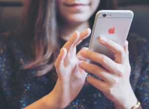 A closeup of a woman using an iPhone