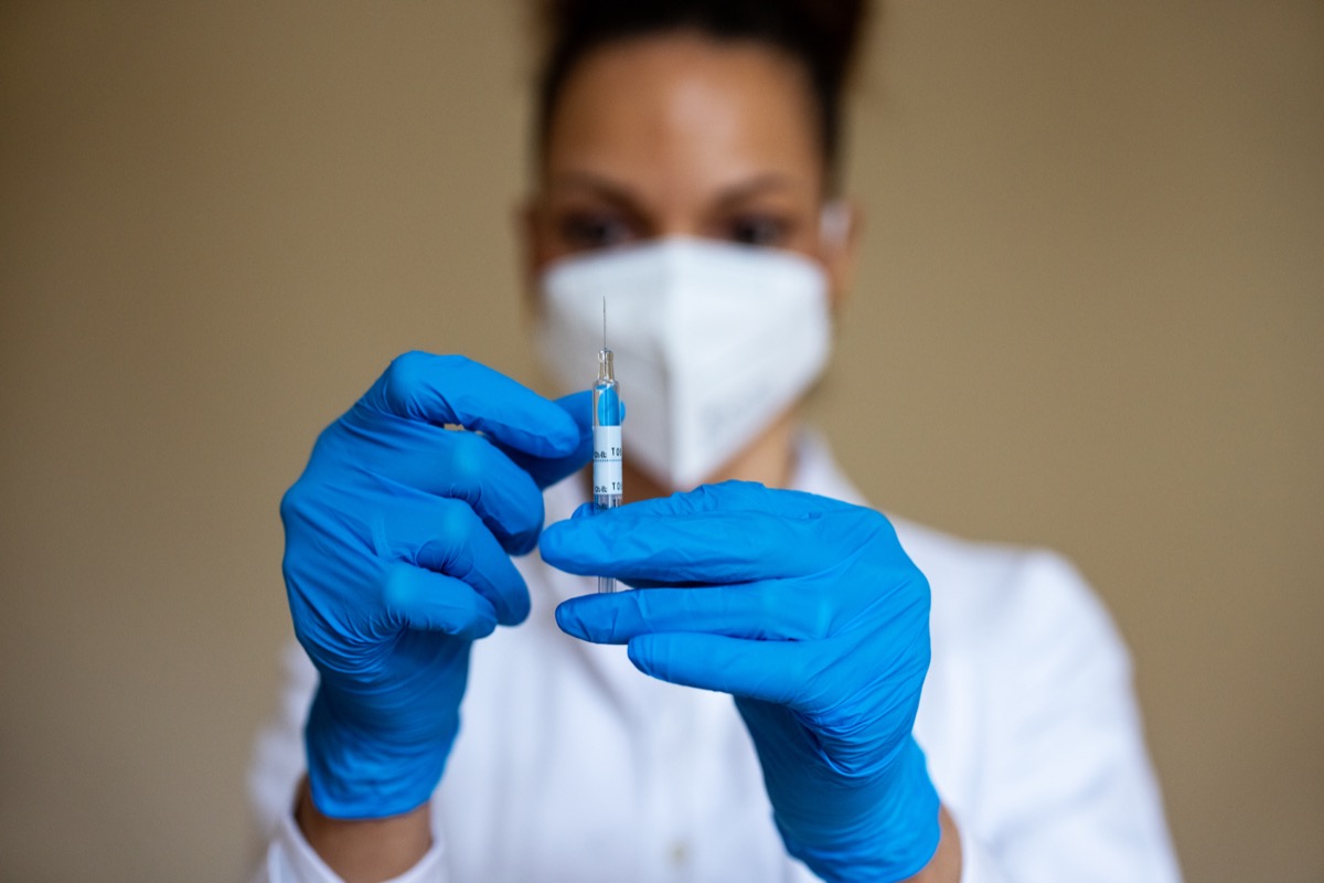 Close-up of a female doctor preparing a COVID-19 vaccine injection for vaccination. Preparation of a coronavirus vaccine dose.