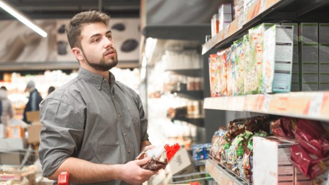 man with beard shopping in supermarket cereal aisle