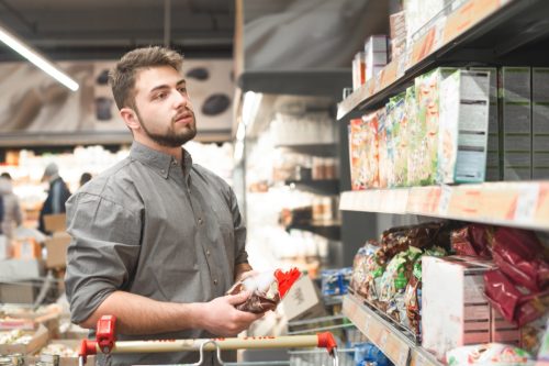 man with beard shopping in supermarket cereal aisle