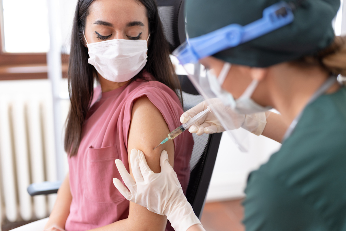 Doctor Giving COVID-19 Vaccination Shot To Her Patient
