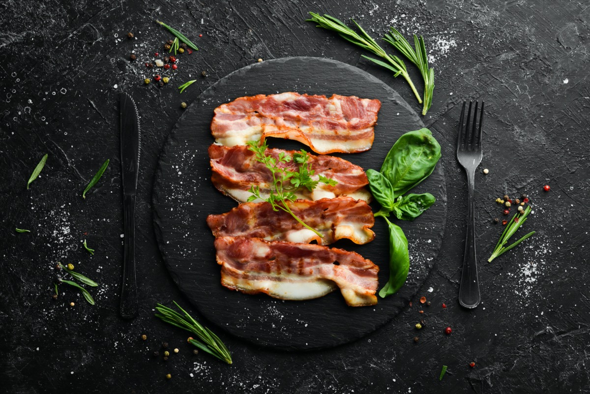Bacon and garnish on black plate