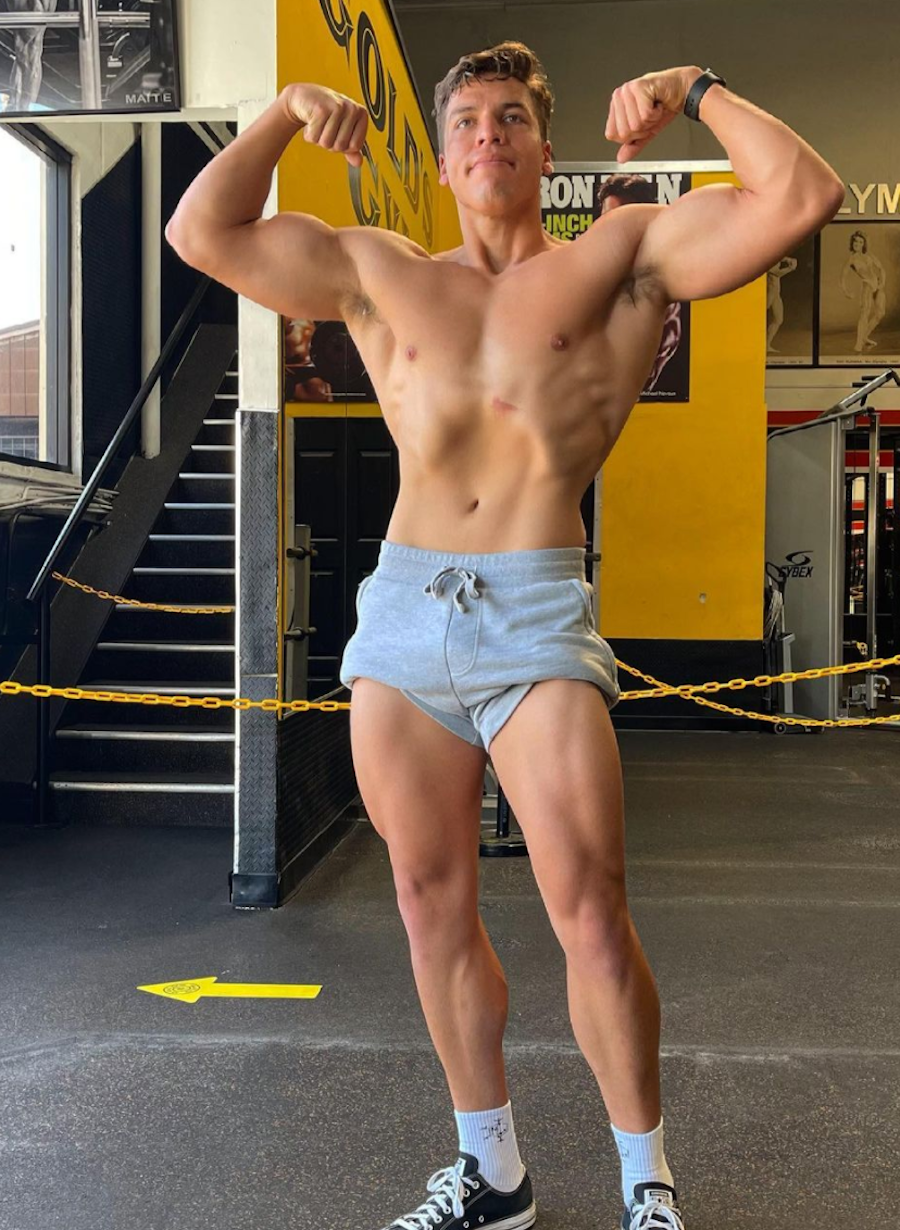 Joseph Baena striking a bodybuilding pose at the gym