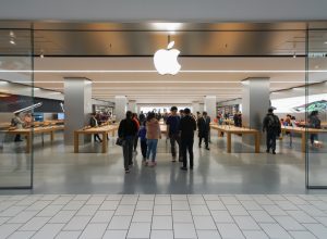 apple store exterior in mall with customers walking in