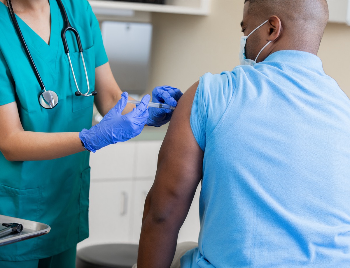 man a vaccination in doctor's office during coronavirus pandemic