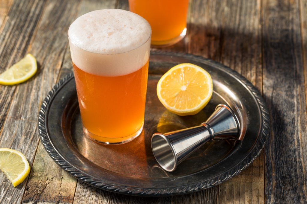 beer, shandy cocktail with lemon