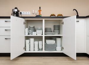 open white cabinet full of dishes