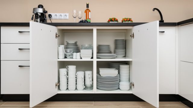 open white cabinet full of dishes