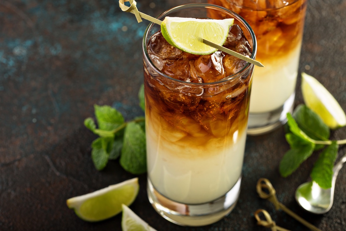 dark and stormy cocktail in glass with lime