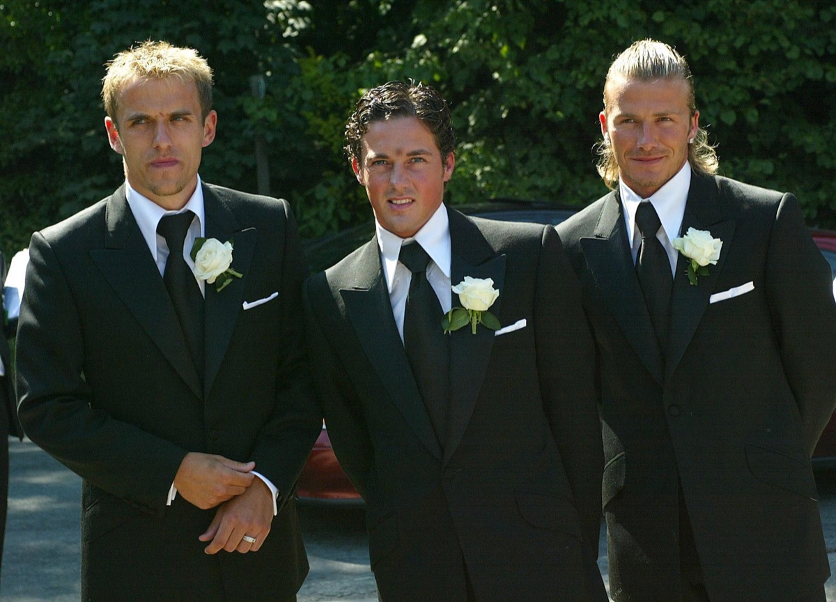 dave gardner and david beckhma posing in suits at wedding with phil neville