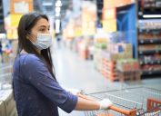 Woman with face mask, shopping for groceries in a supermarket during COVID-19 pandemic