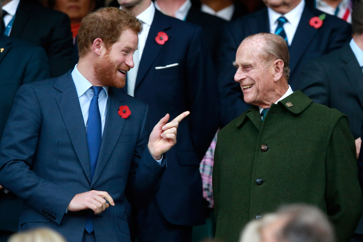Prince Harry and Prince Phillip enjoy the atmosphere during the 2015 Rugby World Cup Final match between New Zealand and Australia at Twickenham Stadium on October 31, 2015 in London, United Kingdom.