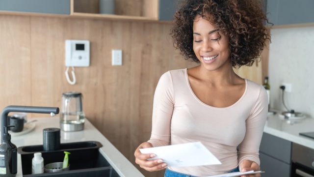 woman at home checking her mail and looking very happy – lifestyle concepts