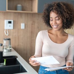 woman at home checking her mail and looking very happy – lifestyle concepts