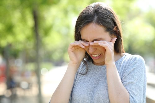 Woman itching her eyes