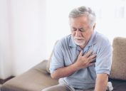 suffering from bad pain in his chest heart attack at home - senior heart disease