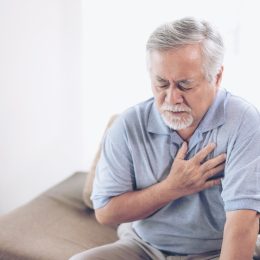 suffering from bad pain in his chest heart attack at home - senior heart disease