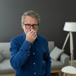 man smells something bad in his house