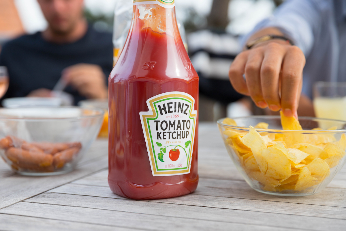 Ketchup and chips on picnic table