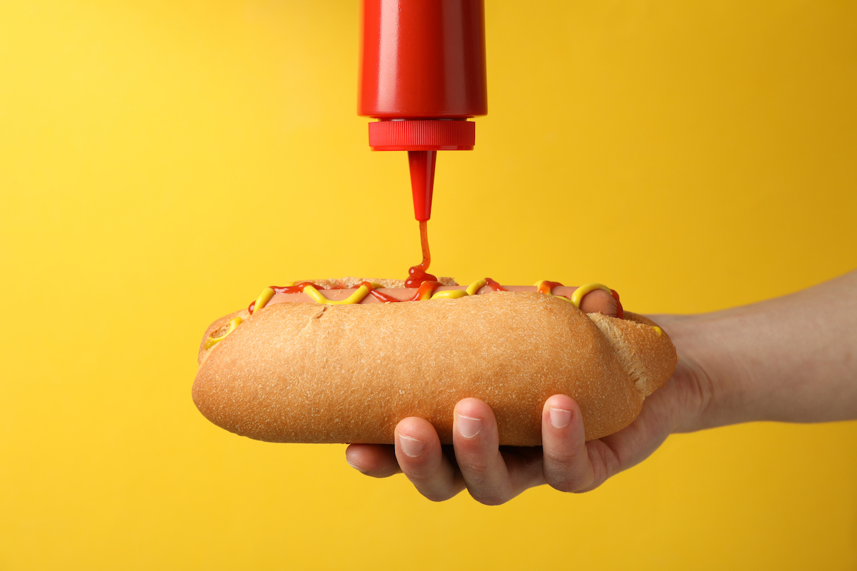 Putting ketchup on a hot dog