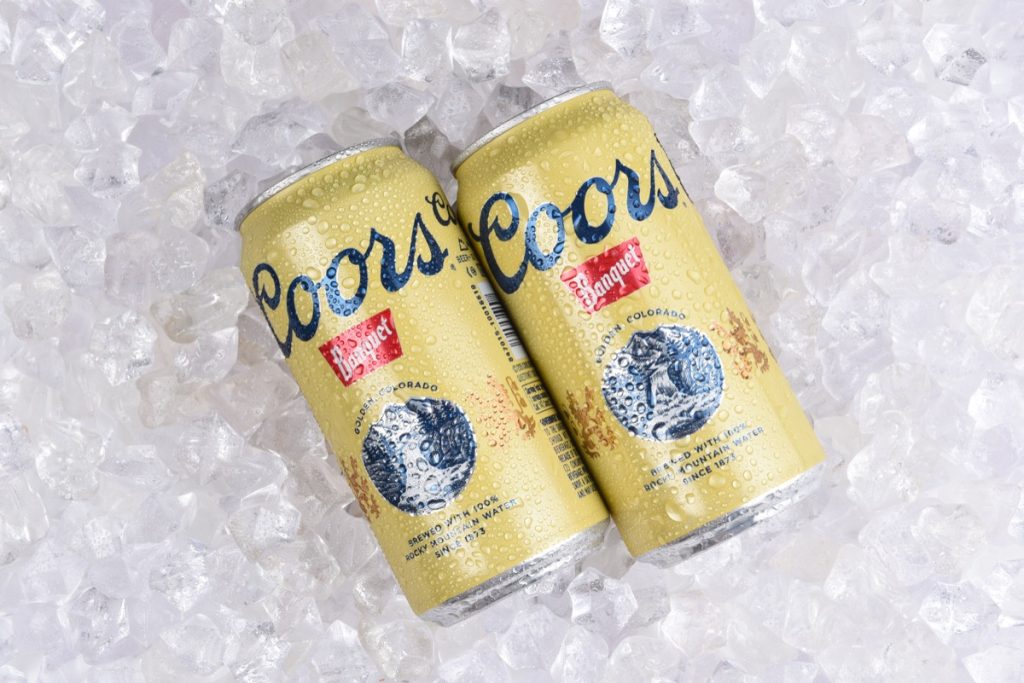 Two cans of coors banquet on ice