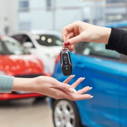 Hands exchanging keys for a new car