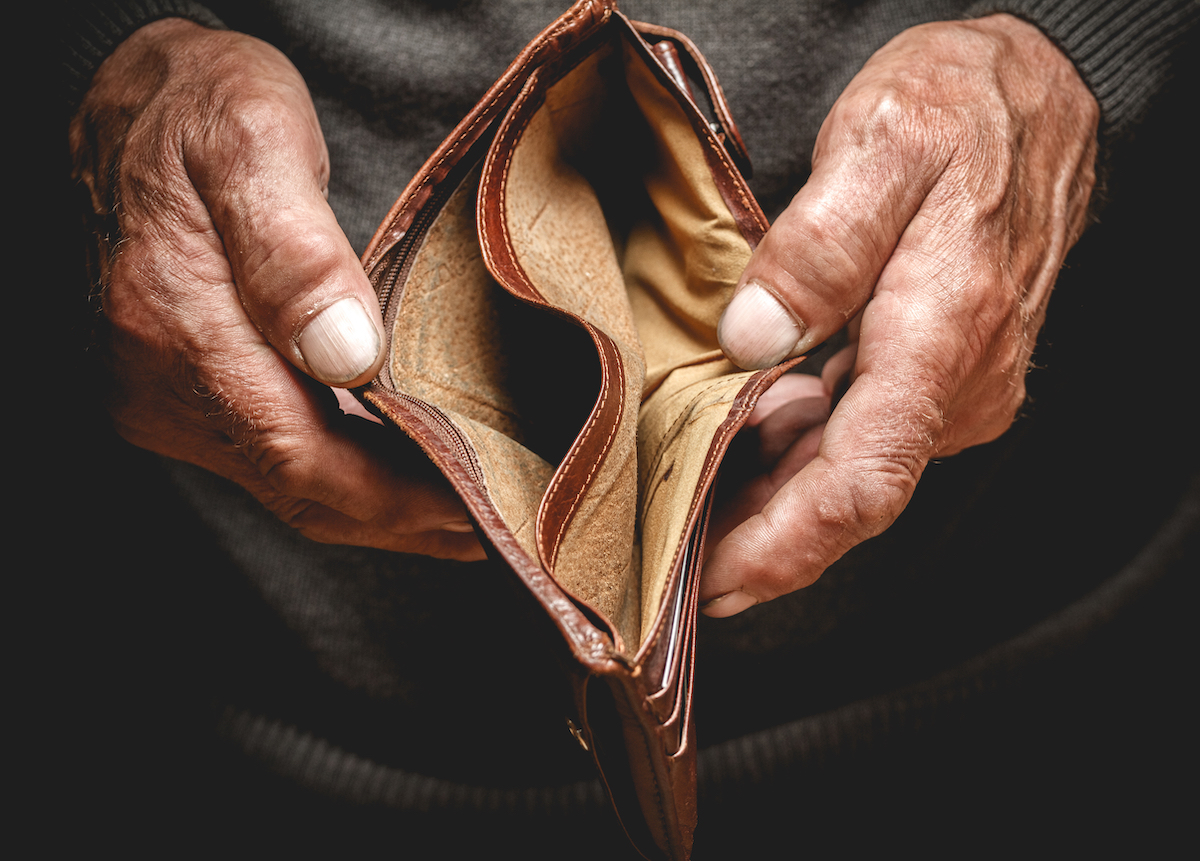 Older person's hand holding an empty wallet