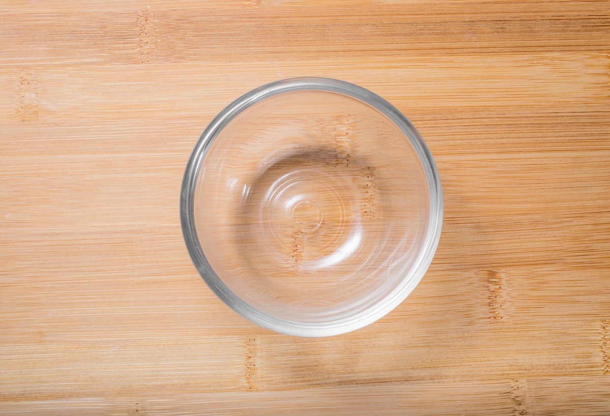 small empty glass bowl on wooden table